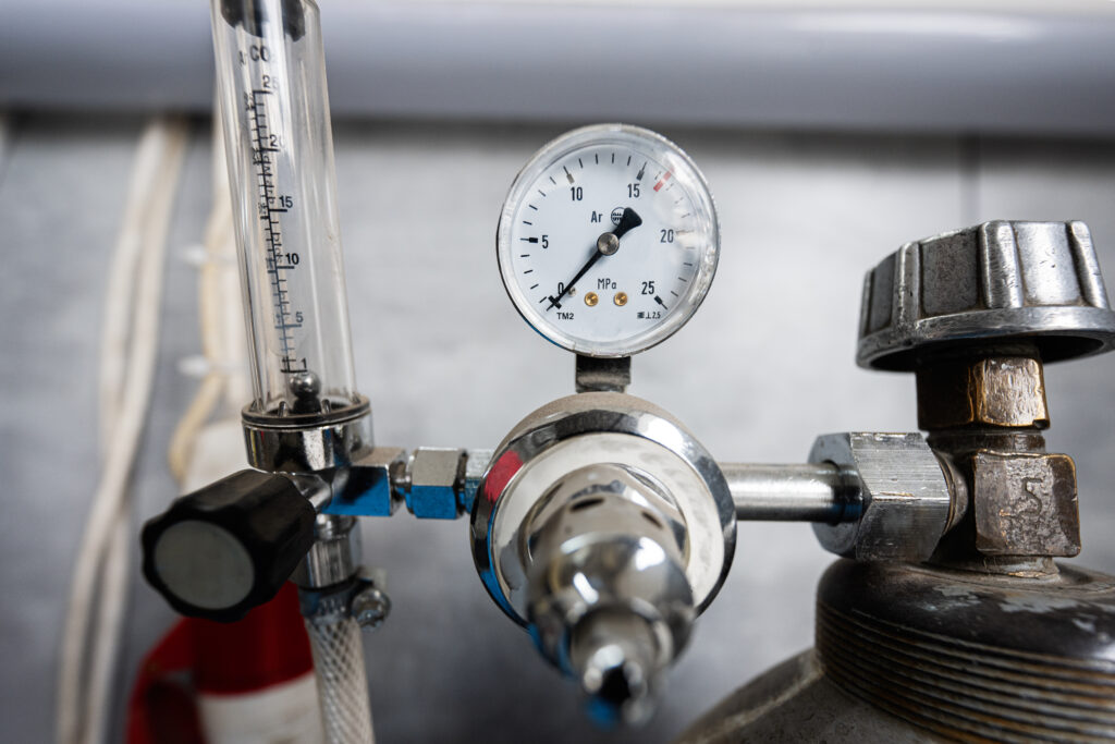 close up of industrial pressure gauge with metal components